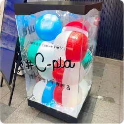 透明ケースに大きなカプセルを入れた、カプセルトイ専門店の看板